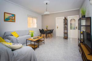 a living room with a couch and a table at CH Limonero Doña Pepa in Rojales
