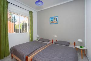two beds in a room with a window at CH Limonero Doña Pepa in Rojales +30 photos