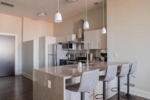 a kitchen with a large island in the middle of a room at Downtown Luxury 2BR Loft in Milwaukee