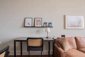 a living room with a table and a couch at Downtown Luxury 2BR Loft in Milwaukee