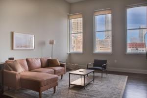 a living room with a couch and a table at Downtown Luxury 2BR Loft in Milwaukee +15 photos