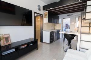 a kitchen with black cabinets and a white counter top at Vistamar in Patalavaca
