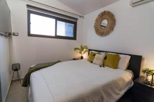 a bedroom with a large bed and a window at Vistamar in Patalavaca
