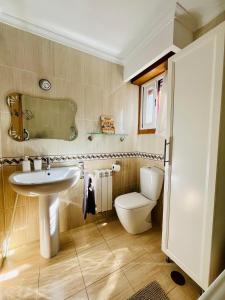 a bathroom with a sink and a toilet at Apartamento en Comillas-Garden Apartment in Comillas in Comillas +29 photos