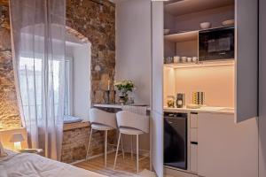a small kitchen with a table and chairs in a room at Studio Palace Gates in Split