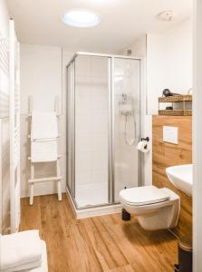 a white bathroom with a shower and a toilet at Amalie Genusskult in Speyer