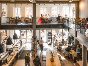 a group of people walking around a store at Amalie Genusskult in Speyer