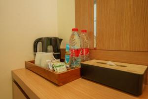a counter with bottles of water and a box on it at The Cabin Hotel Lovina Bali in Pulau Temukus