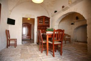 a dining room with a table and chairs in a building at Masseria Montecchie in Ceglie Messapica
