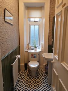 a bathroom with a toilet and a sink at Greenland House B&B in Castletown +44 photos