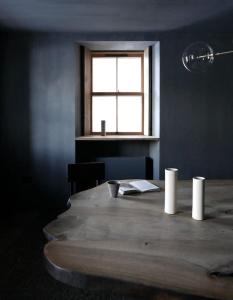 a wooden table in a room with a window at Luxury lodge for 16 in Royal Deeside in Ballater