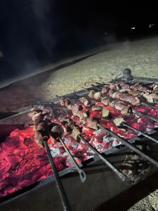 a bunch of meat on a grill at Night Magic Camp in Wadi Rum