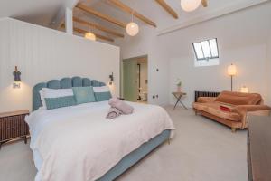 a large bedroom with a large bed and a couch at Tackroom Great Ness Shrewsbury in Great Ness