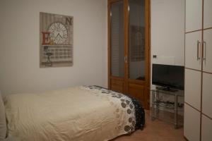 a small bedroom with a bed and a television at Casa Jack in San Giorgio di Piano