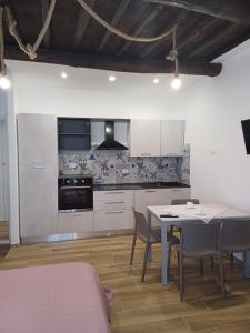 a kitchen and dining room with a table and chairs at Matt house in La Spezia