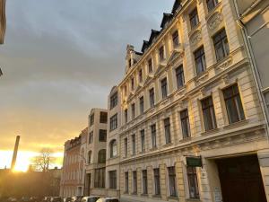 a large building with the sun setting behind it at Haus Gründerzeit in Görlitz