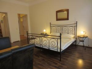 a bedroom with a bed and a couch and a mirror at Haus Gründerzeit in Görlitz