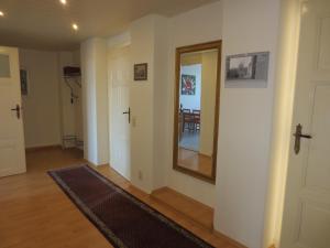 a hallway with a mirror and a dining room at Haus Gründerzeit in Görlitz +49 photos