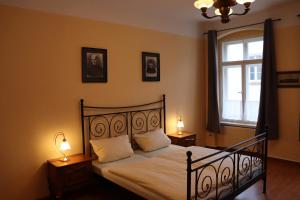 a bedroom with a bed with two lamps and a window at Haus Gründerzeit in Görlitz