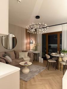 a living room with a couch and a table at Apartament Pod Żaglami 2 in Sława