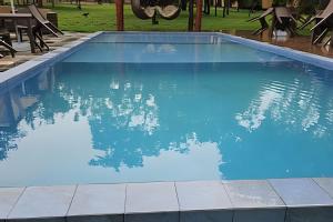 a large swimming pool with blue water at Pousada Cocobeach Adventure - Miracema do Tocantins in Palmas