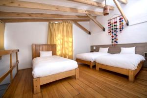 A bed or beds in a room at Inkarri Cusco