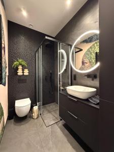 a bathroom with a sink and a shower and a toilet at Apartament Pod Żaglami 2 in Sława +12 photos