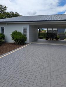 a house with a brick driveway in front of it at Southern Comfortable in Goolwa North