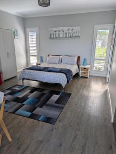 a bedroom with a bed and a rug at Southern Comfortable in Goolwa North
