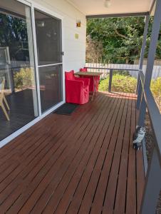a screened porch with a table on a deck at Southern Comfortable in Goolwa North +5 photos