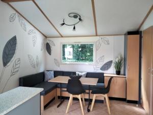 a caravan dining room with a table and chairs at Domaine de Pimont in Yerville