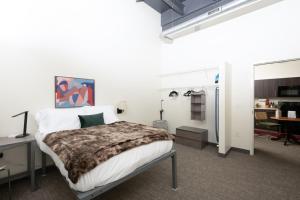 a bedroom with a bed and a desk and a table at Cream City 2BR Apt - Just 3 Blocks to Fiserv with Gym and Parking in Milwaukee +17 photos