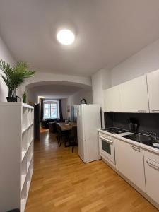 a kitchen with a white refrigerator and a table at homy Downtown Elegance in Feldkirch