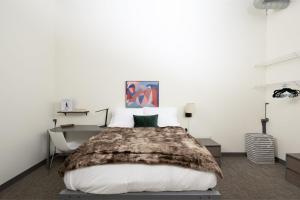 a bedroom with a large bed and a desk at Cream City 2BR Apt - Just 3 Blocks to Fiserv with Gym and Parking in Milwaukee