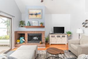 a living room with a couch and a fireplace at Quiet Villa on Dataw Island with Creek Views in Dataw Island