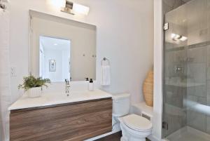 Un baño con lavabo, inodoro y ducha. en Iconic Modern Stay w Free Parking, en Spokane 25 fotos más