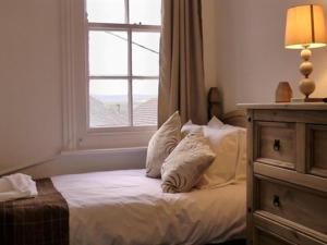 a bedroom with a bed with pillows and a window at Stonehenge Inn in Durrington +21 photos