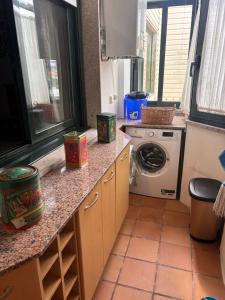 a kitchen with a washing machine on a counter at Duplex Bueu Vistas con terraza in Bueu