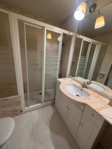 a bathroom with a sink and a shower at Duplex Bueu Vistas con terraza in Bueu +16 photos