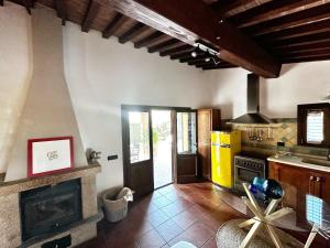 a kitchen with a stove and a fireplace at Tuscany Cottage Paratino 53 by Zoom In Earth in Cecina +17 photos