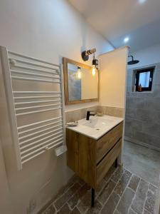 a bathroom with a sink and a mirror at Maison de charme in Apt