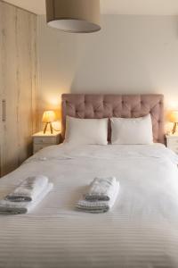 a bed with two towels on it with two lamps at Santa Marina 6 in Ioannina