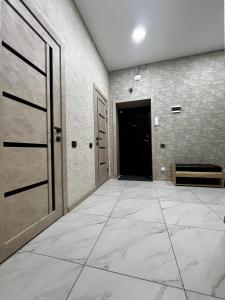 an empty hallway with a door and a tile floor at 2х комнатная квартира ЖК Арман in Kokshetau