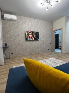 a living room with a tv on the wall at 2х комнатная квартира ЖК Арман in Kokshetau