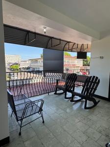 a group of benches sitting on top of a balcony at Panamá Hostels Inn in David +45 photos