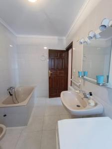a white bathroom with a tub and a sink and a tub at The living mountain - SAJA - CASONA RURAL in Saja +36 photos