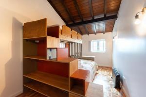 a bedroom with a bed and wooden shelves at Casa de Maiorca in Maiorca +34 photos