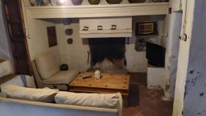 a living room with a couch and a fireplace at La Casa de Corruco in Casabermeja