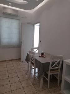 a dining room with a table and chairs at Villa Vasiliki in Amorgos