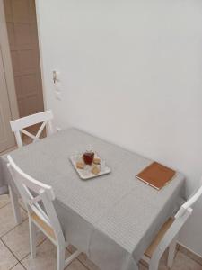 a table with a plate of food and a book on it at Villa Vasiliki in Amorgos